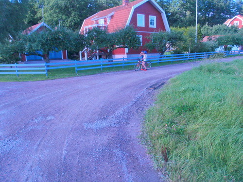 Girls talking and sharing a bike.